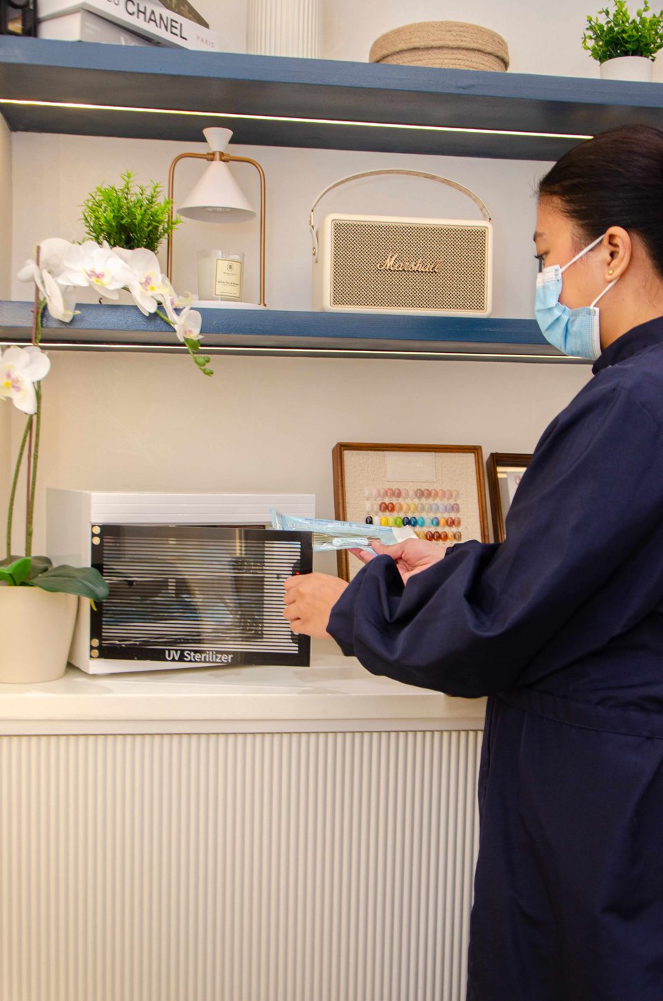 Staff placing sterilized tools into UV sterilizer