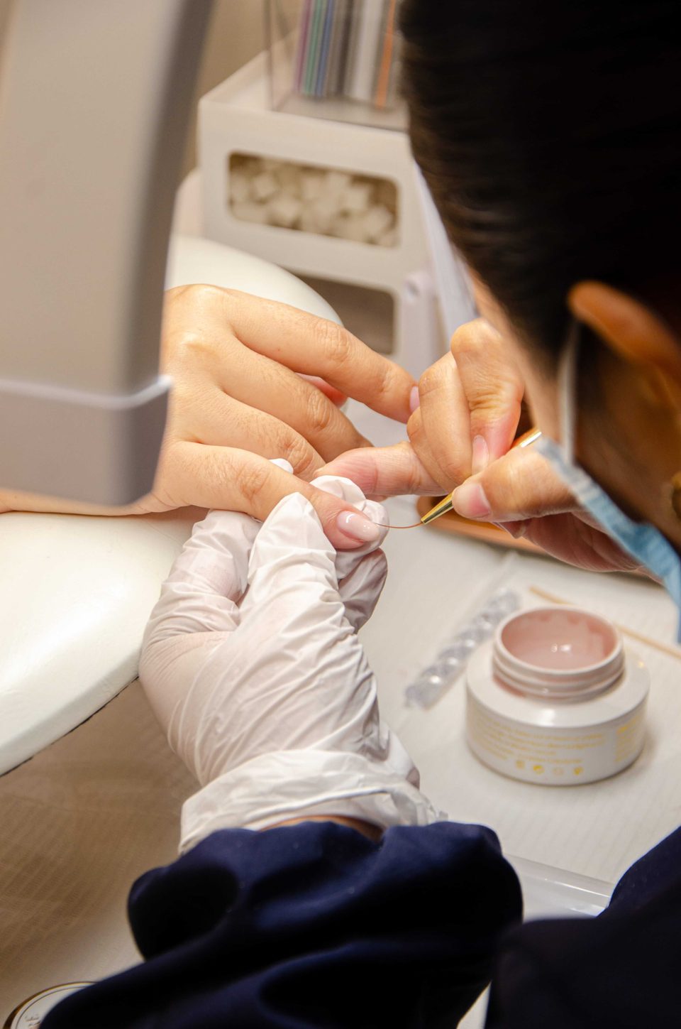 Nail technician performing detailed manicure